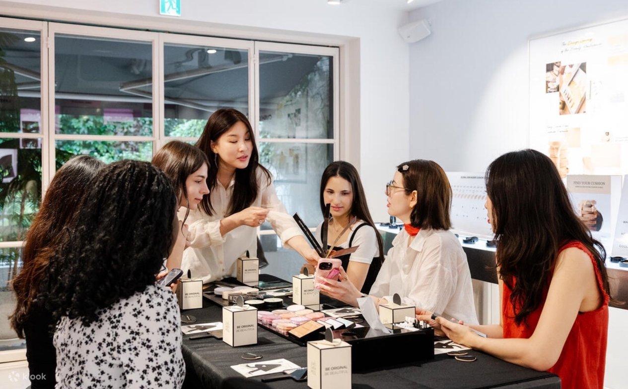 Professional makeup artist demonstrating techniques to a small learning group
