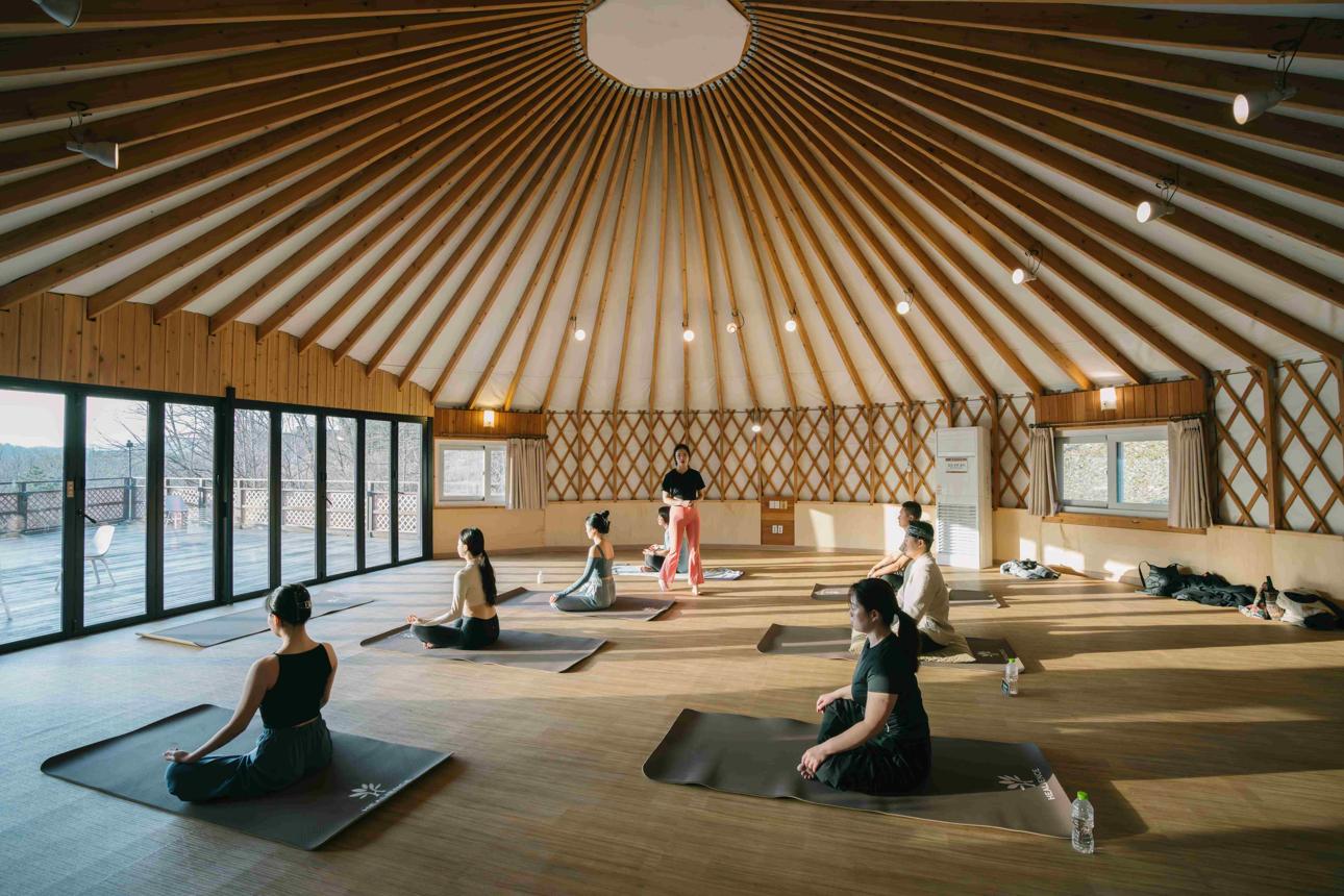 Yoga class in a spacious timber retreat studio